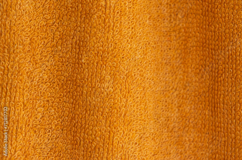 Orange microfiber cloth, close-up, selective focus.