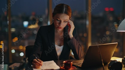 Woman overwork late office typing laptop. Busy manager analysing papers report