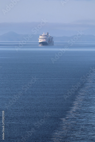 Distant cruise ship in ocean off Alaska coast