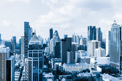 Closeup image of Bangkok cityscape. Modern skyscrapers with monochrome blue filter. Modern architectural building skyline with blue sky. Side view. Business background. Day light. Ornamented. photo