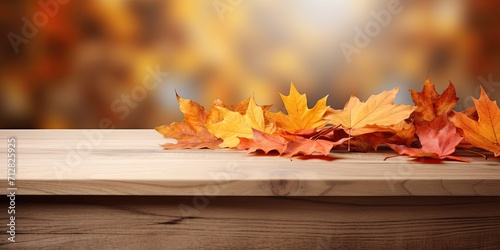 Autumn leaves and wooden pedestal sit on kitchen table.