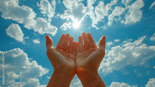 Prayer. A petition from God. Hands are turned towards the sun. photo