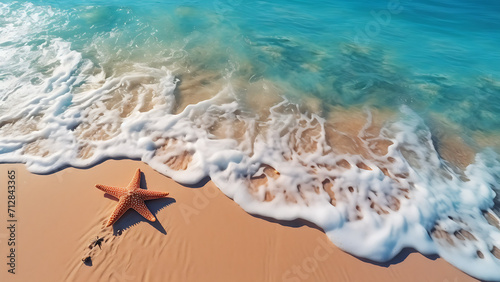 Starfish on the sand beach in clear sea water.