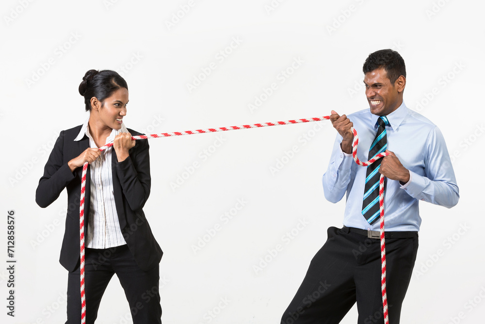 Samolepka Two Indian business people playing tug war.