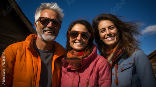 Farm Family posing in front of a barn - all-American family - winter - cold weather - low angle shot - wholesome - happy 