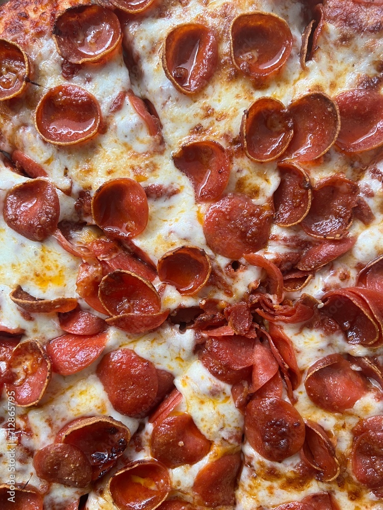 Whole large pepperoni pizza in cardboard box from delivery - overhead top view. Whole large pepperoni pizza in cardboard box from delivery - overhead top view.