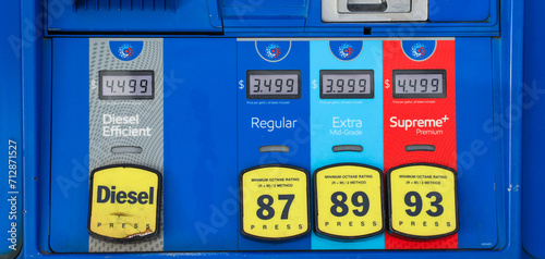 gas pump nozzle with rising numbers on the display, symbolizing inflation and escalating gas prices