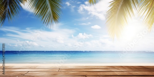 Wooden table with tropical beach background, including blue sea, white clouds, sun flare, and palm tree leaves.