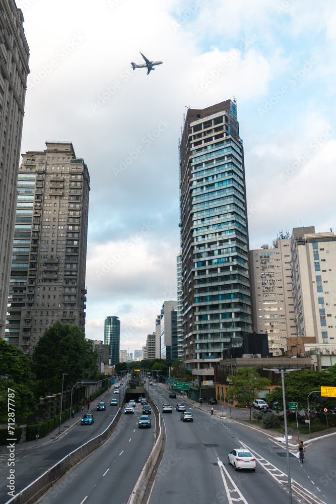 Urban landscape of the city of São Paulo with plane over the buildings, Brazil. Avenida Cidade Jardim.