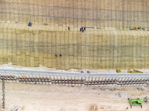 Wallpaper Mural Mountain road constraction. Workers reinforce the slope over the new road. Road construction in progress on slope nature canyon. Infrastructure development and logistics. Aerial drone shot Torontodigital.ca