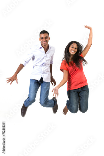 Excited group of Indian men and women jumping for joy.