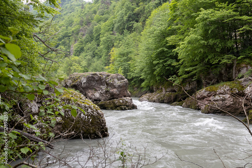 The banks of a mountain river, the riverbed in a granite canyon and the swift current. photo