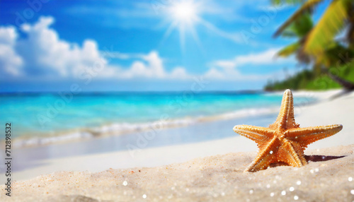 Starfish on sandy beach with blue sea and sky background. Summer vacation concept.