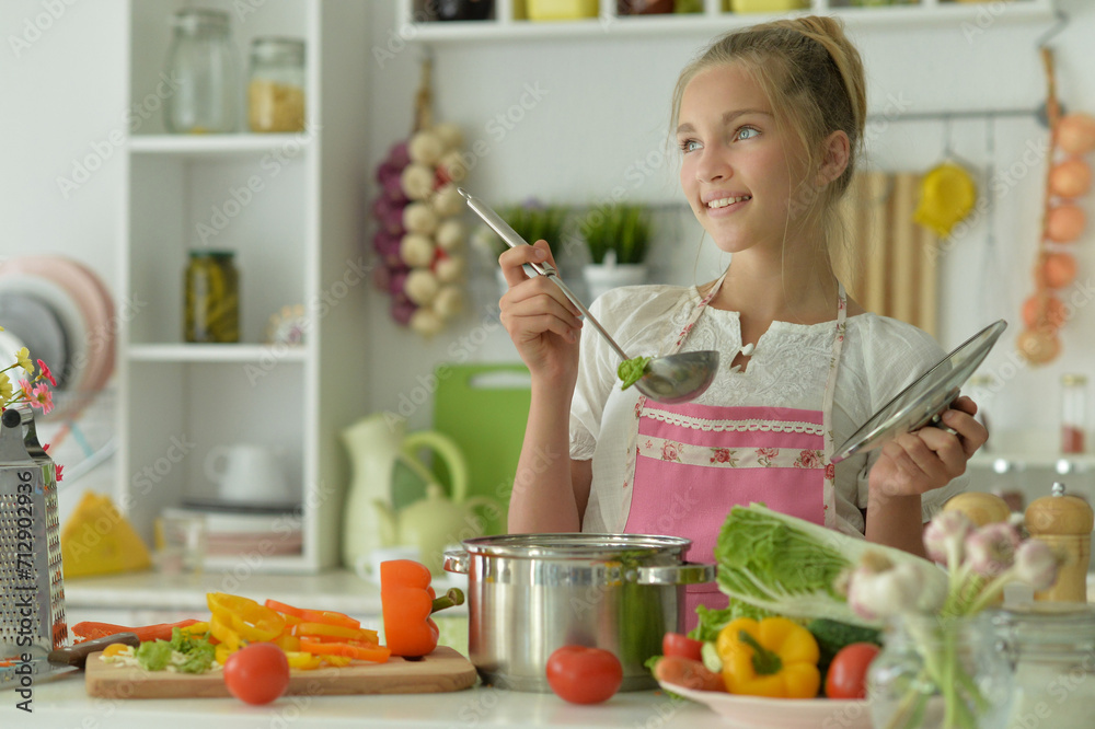 Portrait of a beautiful girl preparing a salad in the kitchen Portrait of a beautiful girl preparing a salad in the kitchen