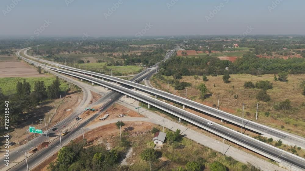 Drone shot scenic landscape Aerial view of rural highway traffic. Countryside road traffic with crossroad Drone shot scenic landscape Aerial view of rural highway traffic. Countryside road traffic with crossroad