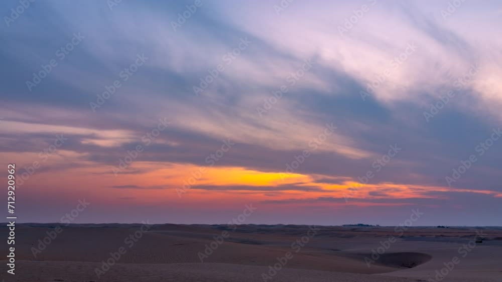 Beautiful dramatic clouds sunset sunrise time lapse over the desert sand dune of Abu Dhabi, UAE Beautiful dramatic clouds sunset sunrise time lapse over the desert sand dune of Abu Dhabi, UAE