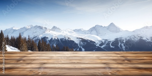 Snow-capped Alpine background and an exuberant image of an empty wooden table top. © Sona
