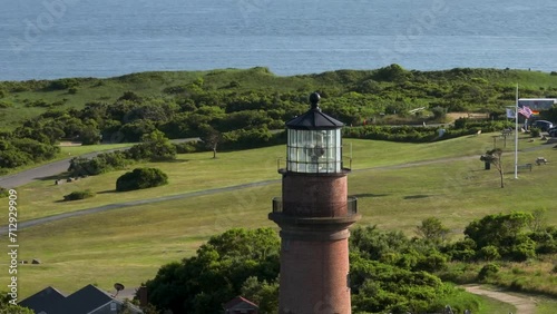 Tight orbiting aerial shot of the Gay Head Lighthouse in Martha's Vineyard. photo
