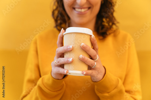 Anonymous woman with takeaway coffee