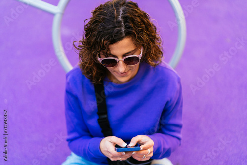 Focused woman browsing smartphone on playground