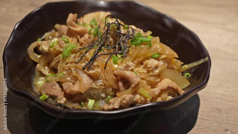 Close-up view of the Japanese cuisine Donburi chicken rice with egg ,seaweed and onion. Close-up view of the Japanese cuisine Donburi chicken rice with egg ,seaweed and onion.