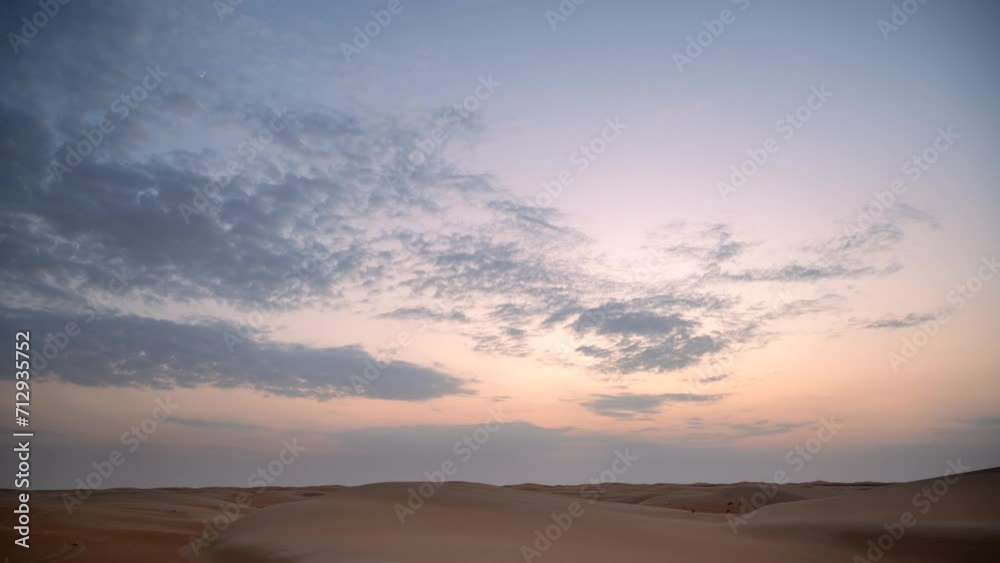 Beautiful dramatic clouds sunset sunrise time lapse over the desert sand dune of Abu Dhabi, UAE Beautiful dramatic clouds sunset sunrise time lapse over the desert sand dune of Abu Dhabi, UAE
