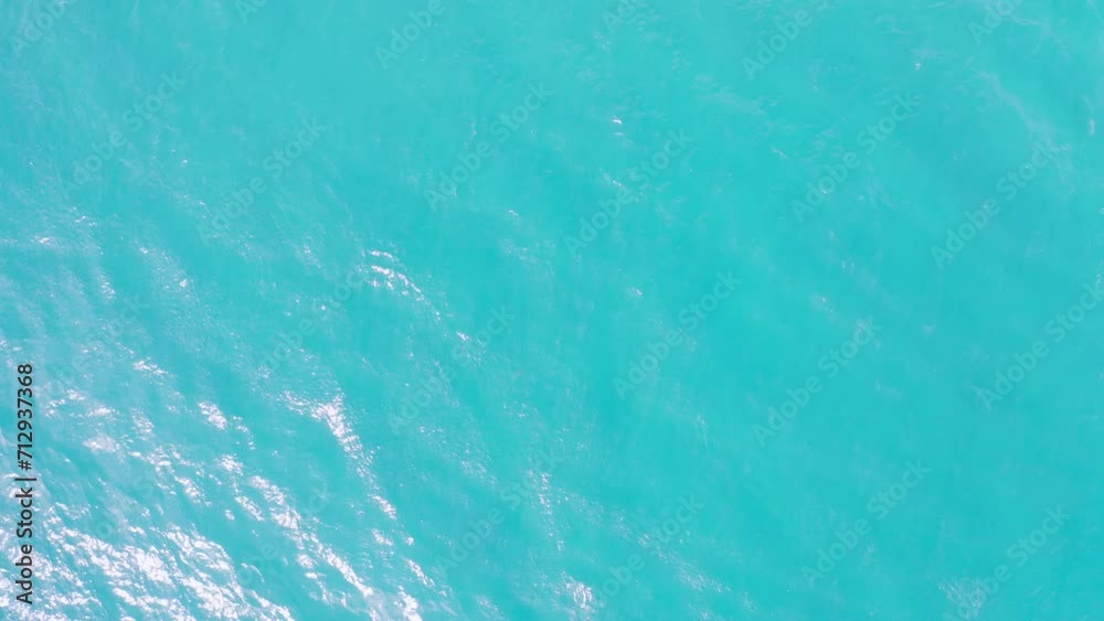 Aerial drone top view of turquoise ocean water surface. The wind blowing is causing small waves. Aerial drone top view of turquoise ocean water surface. The wind blowing is causing small waves.