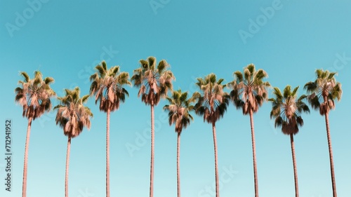 A symmetrical shot of a row of identical palm trees against a clear blue sky. -Generative Ai