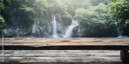 Wooden table with a waterfall backdrop in summer