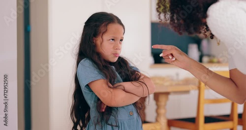 Angry mom, girl child and discipline for writing on wall, shouting and sad for mistake in family home. Kid, mother and daughter with pointing, pencil and talking with drawing in living room at house photo