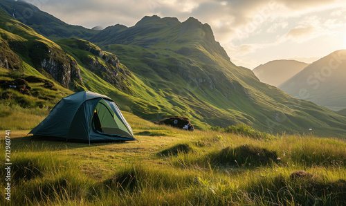 Green tent amidst the rolling hills of the Scottish Highlands.