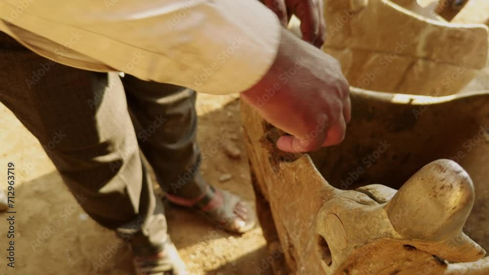 Workers repair a excavator soil bucket teeth with help of wrench at the site Workers repair a excavator soil bucket teeth with help of wrench at the site