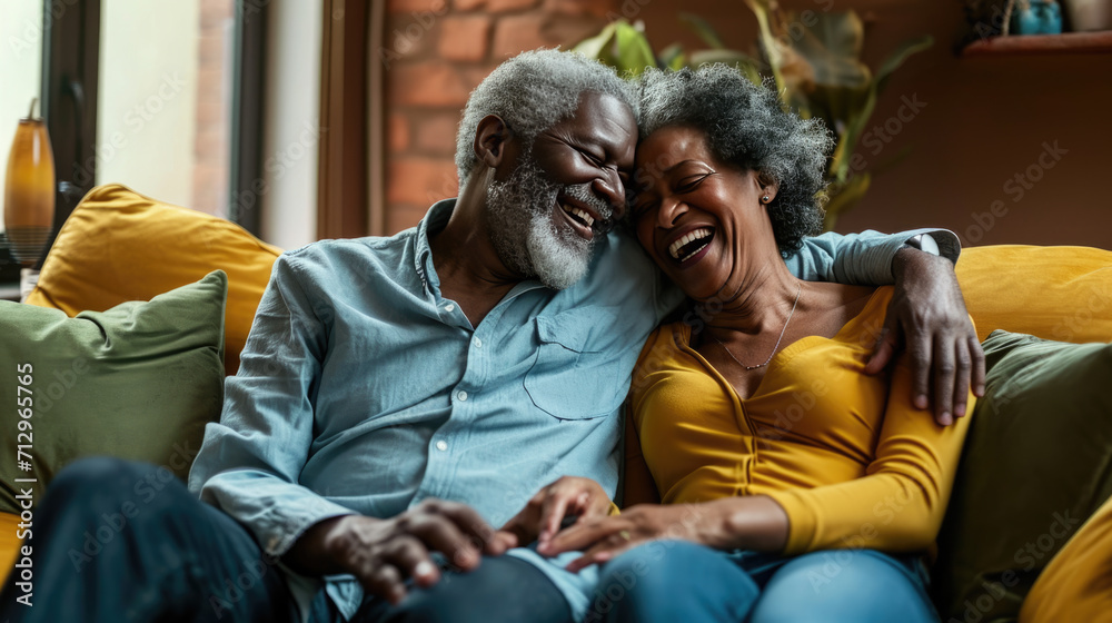 Senior couple is laughing and embracing each other on a couch, sharing a joyful moment together. Senior couple is laughing and embracing each other on a couch, sharing a joyful moment together.