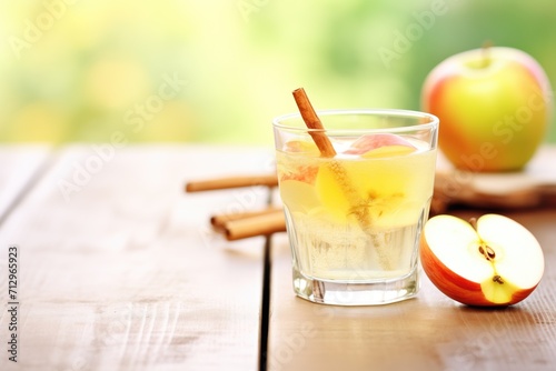close-up of fizzing apple cider vinegar drink with apple slices photo