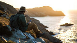 Traveler is sitting on a rocky cliff, reading a book with a serene sunset over the sea in the background