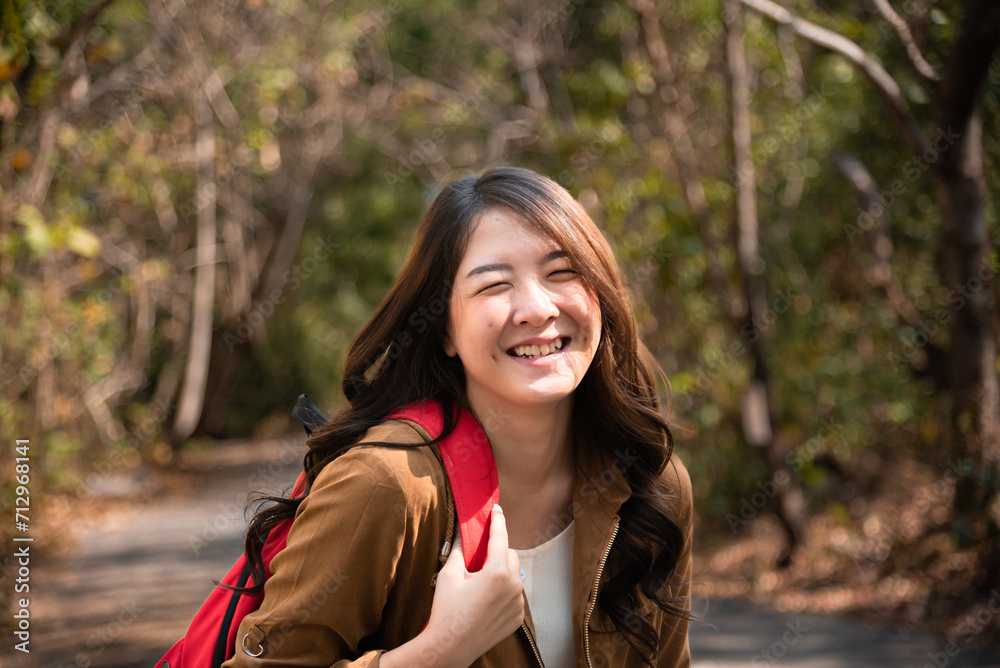 Smart Asian girl in jungle suit walking trail travel alone in the Autumn field sunlight, lifestyle adorable young woman enjoy smiling feeling freedom happy in wild forest park spent the holiday vacati Smart Asian girl in jungle suit walking trail travel alone in the Autumn field sunlight, lifestyle adorable young woman enjoy smiling feeling freedom happy in wild forest park spent the holiday vacati