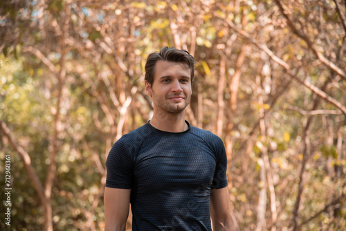 Portrait of happy caucasian handsome man confident and outdoors fitness. Muscular afro guy resting for a break after running outdoor. Fitness man taking a break after running workout.