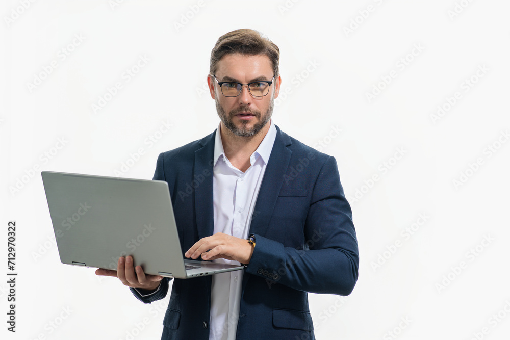Business man in suit using laptop. Male businessman worker watch video on computer laptop. Serious man hold laptop computer. Man in glasses work with laptop, studio isolated portrait on white. Business man in suit using laptop. Male businessman worker watch video on computer laptop. Serious man hold laptop computer. Man in glasses work with laptop, studio isolated portrait on white.