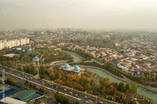 Top view from the observation deck on the Tashkent TV tower to central part of the city covered with smog at sunset . Air polution in city.
