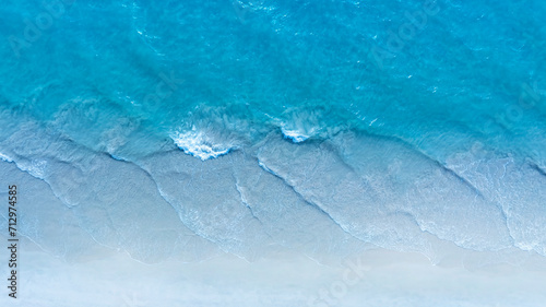 The soft wave water of the sea on the sandy beach background