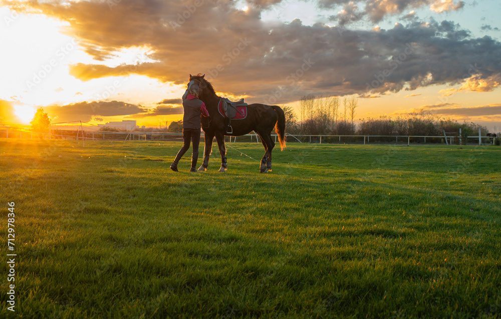 Woman and her horse on a sunset Woman and her horse on a sunset