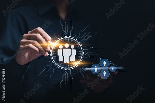 Businessman touching virtual HR icons for recruitment process to work efficiently and achieve sustainable business success. team building. Human Resources HR management concept. © Pakin