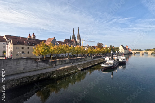 Regensburg on the Danube with stone bridge in sunshine and clouds in autumn © helfei