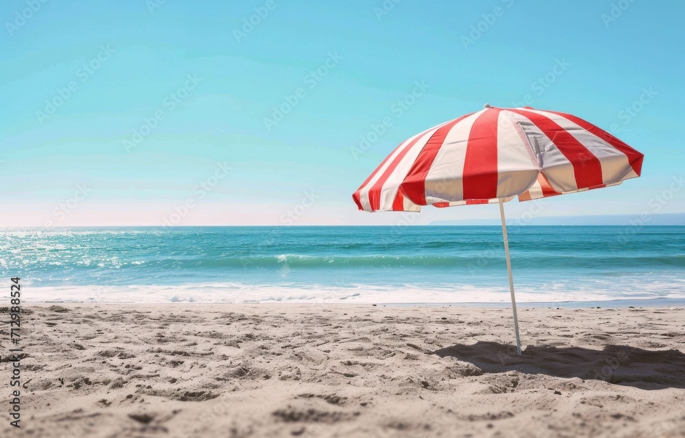 an outdoor red and white striped umbrella on a beach an outdoor red and white striped umbrella on a beach