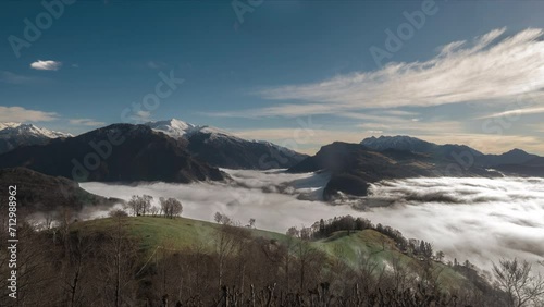 Time-lapse with low fog in mountain valley