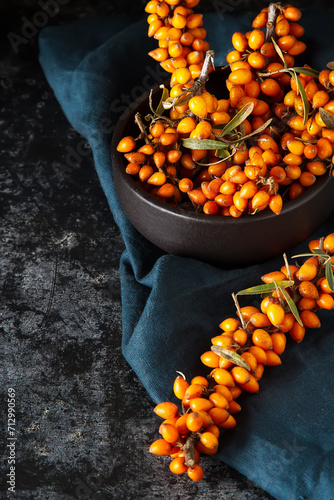 Ripe orange berry, sea buckthorn. Vitamins. Dark background