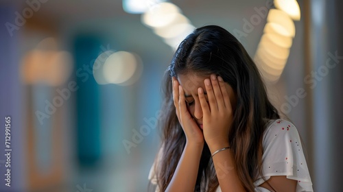 young indian college girl crying at college corridor photo