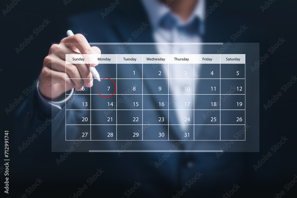 Businessman manage time on virtual screen of calendar for effective work. Highlight appointment reminders and meeting agenda on the calendar. Time management concept. - obrazy, fototapety, plakaty 