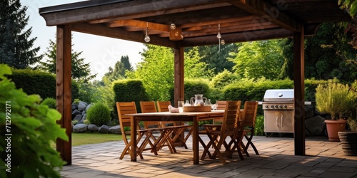 Outdoor dining area with empty table and barbecue
