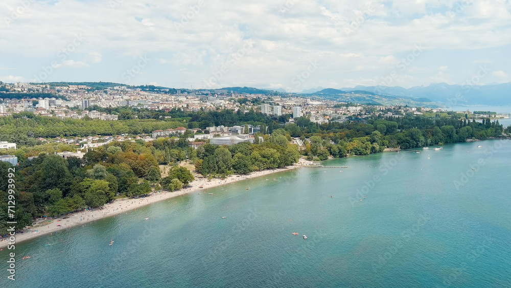 Lausanne, Switzerland - July 16, 2023: The new building of the International Olympic Committee is located on the shores of Lake Geneva. Summer day, Aerial View